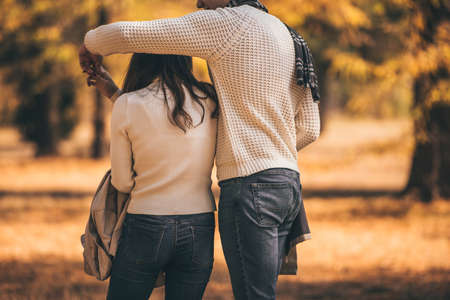 Urban couple is spending carefree time together in the wood, looking at the trees and admiring the beautiful natureの写真素材