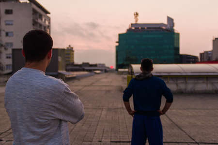 Two friends standing and watching terrain to doing parkourの写真素材