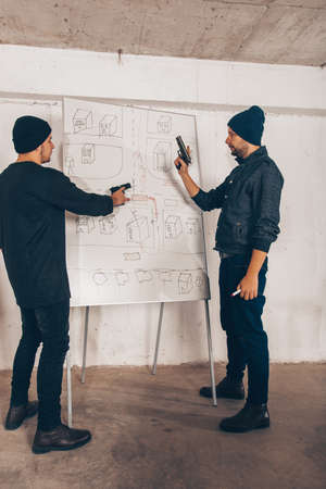 Stealers are making escape plan while holding gunsの写真素材