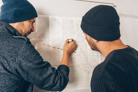 Dangerous thiefs are looking on the map and taking a notes