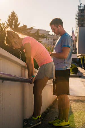 Young couple jogging for fitness in urban environment on a beautiful summer day