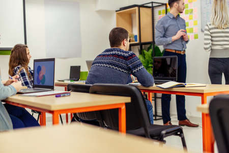 Young students are in classroom, they are looking interested at their classmate
