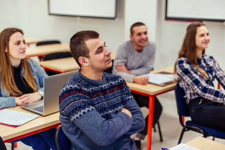 Students sitting in the classroom and listening carefully to their professor