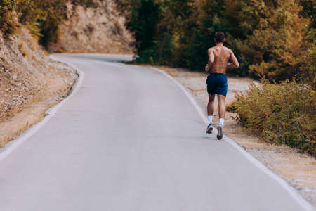 Runner man running sprinting for success on run. Male athlete runner training at fast speed