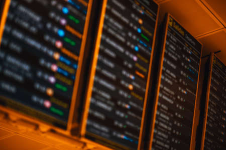 Blurry displays showing time, destination, gate and status of flights