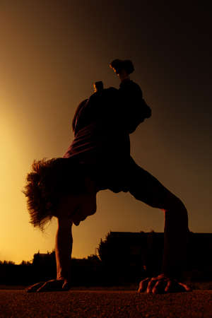 Young silhouette sportive person doing parkour and athletic stuntsの写真素材
