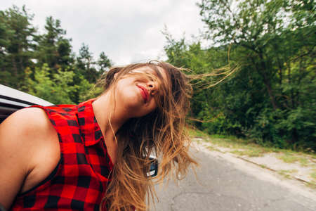 A woman is looking serios while  is driving in some region with small stonesの写真素材