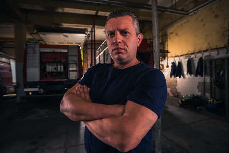 Portrait of fireman standing inside the fire department