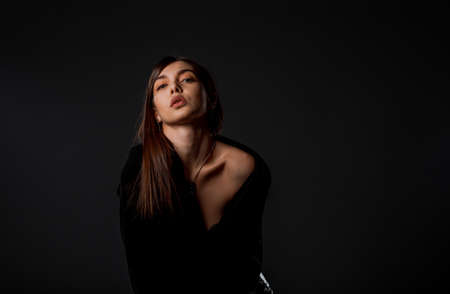 Body shot of an attractive female model posing in modern style clothes