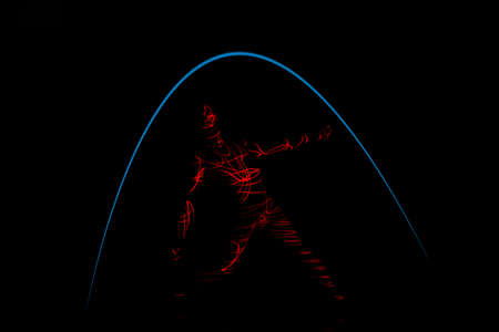 Laser beams shape of a slender dancer performing modern style dance moves