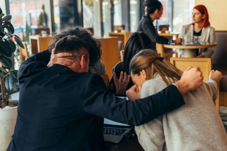 Group of young multiethnic friends bonding and having fun in a coffee shopの写真素材