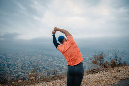 Fit athletic mature runner during a running exercise preparationの写真素材