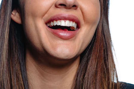 Close up shot of a young woman with white teeth smiling