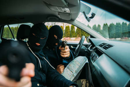 Gangster pointing with their guns at the camera.の写真素材