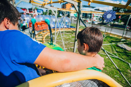 Happy young brothers having good time at the local amusement parkの写真素材