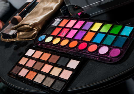 Makeup set. Professional multicolor make up eyeshadows palette and brushes, bright vivid colors and tints of eye shadows set backgroundの写真素材