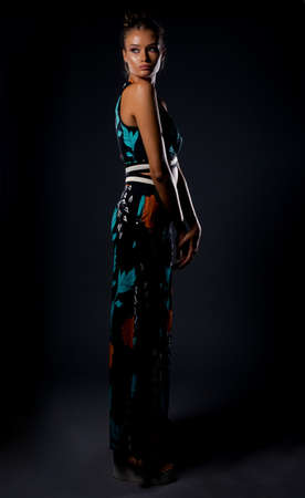 Studio body shot of an attractive woman posing in stylish clothesの写真素材