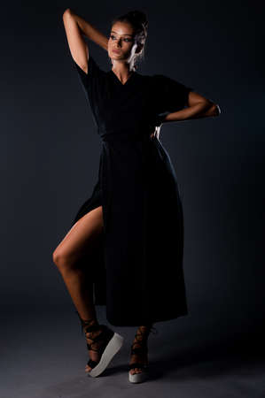 Studio body shot of an attractive woman posing in stylish clothesの写真素材
