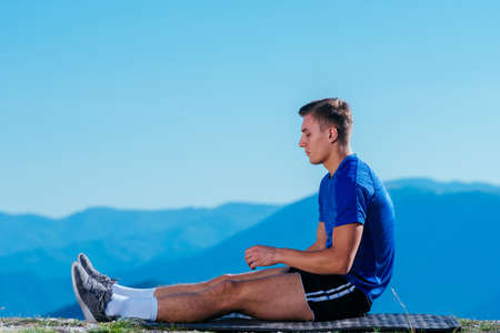 Athlete, long distance runner stretching his legs in nature.Getting ready for a run.
