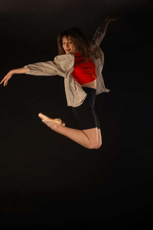 Beautiful ballerina is jumping while posing in the airの写真素材