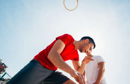 Close up portrait of two basketball players while the push each other for ball possession.