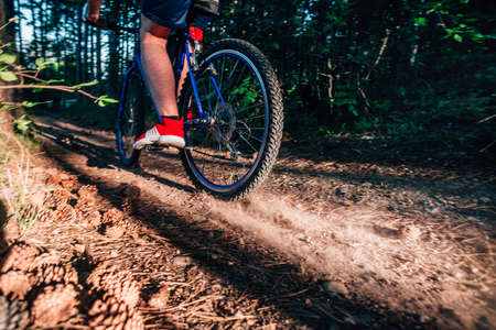 Biker riding his bike on a dirt trail through the woods, Xtreme cycling.の写真素材