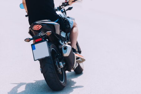 Driver riding motorcycle on an empty asphalt road on the mountainの写真素材