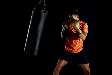 Professional boxer fighting and training in gym. Strong, muscular man training and boxingの写真素材