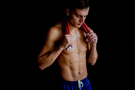 Shirtless sweaty man having break after practicing bodybuidlingの写真素材