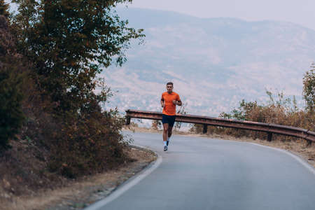 Sportive man is runs in the mountains. Functional training of the runnerの写真素材