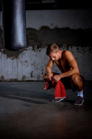 Man showing off his muscular physique. Photo of man with perfect body after trainingの写真素材