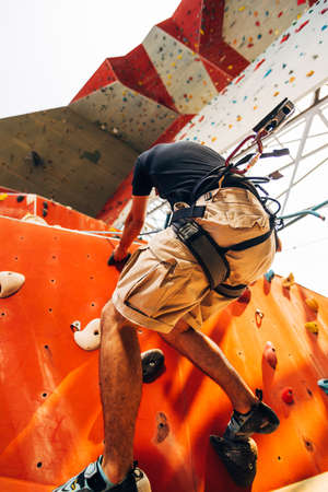 Free climber man climbing up on boulderingの写真素材