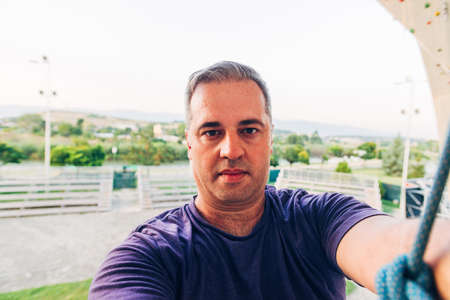 Man climber on artificial climbing wall in bouldering gymの写真素材