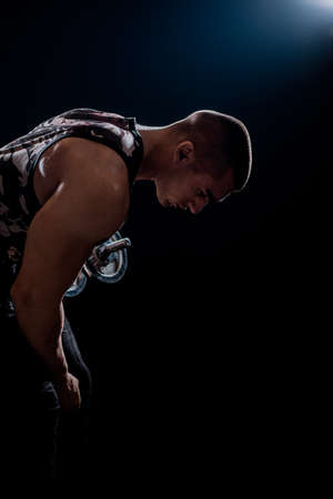 Young male bodybuilder doing exercise with heavy weight dumbbellsの写真素材