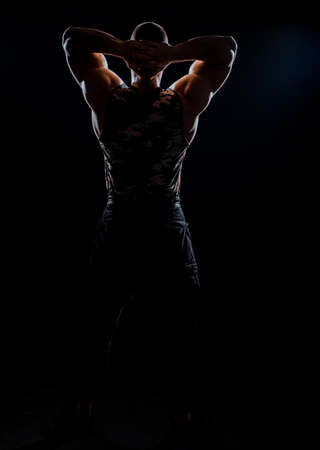 Front view body of muscular biceps sportsman or bodybuilder isolate on black backgroundの写真素材