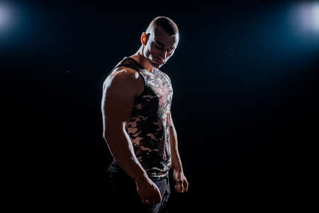 Muscular super-high level handsome man posing on black backgroundの写真素材