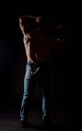 Front view body of muscular biceps sportsman or bodybuilder isolate on black background