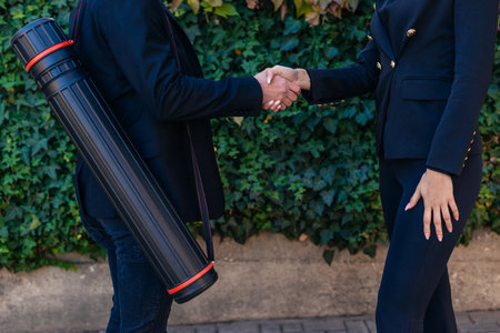 Young attractive businesswoman shaking hands with her colleague for a deal outdoorsの写真素材