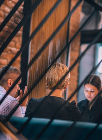 Business meeting inside a cafe with the focus through a fence.の写真素材