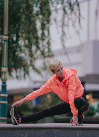 Sporty athletic young woman exercising in an urban city areaの写真素材