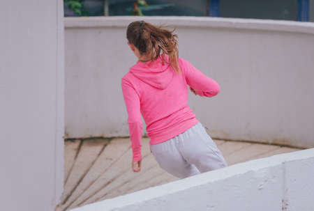 Young attractive girl wearing sportswear during a run in an urban areaの写真素材