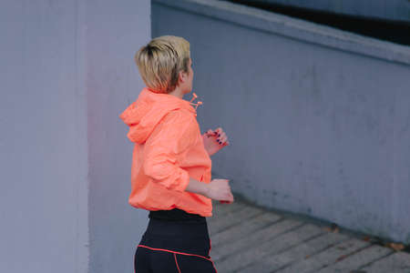 Sporty athletic young woman exercising in an urban city area