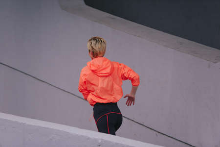Young healthy female runner during an urban workout routineの写真素材