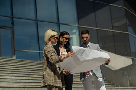 three business partners with sun glasses are not very satisfied with the plan