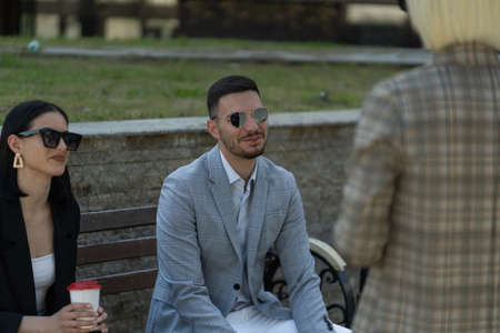 Three business partners are smiling about the ocnversation they are having outside