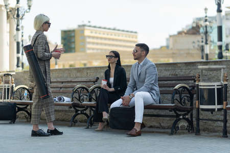Three business people are talking abou the plan for their businessの写真素材
