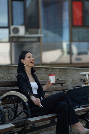 Attractive businesswoman is laughing so much at her breakの写真素材