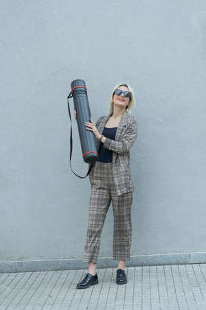 Urban businesswoman is holding the architecture bag in her hands