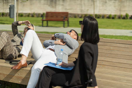 Three urban businss people are on their break from workの写真素材