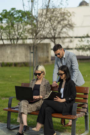 Three urban business peopel are looking a the plan for their companyの写真素材